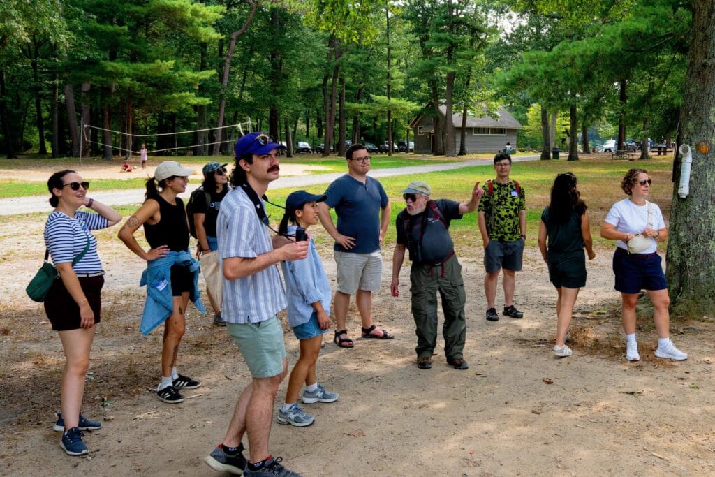 staff standing under a tree at a park on a beach